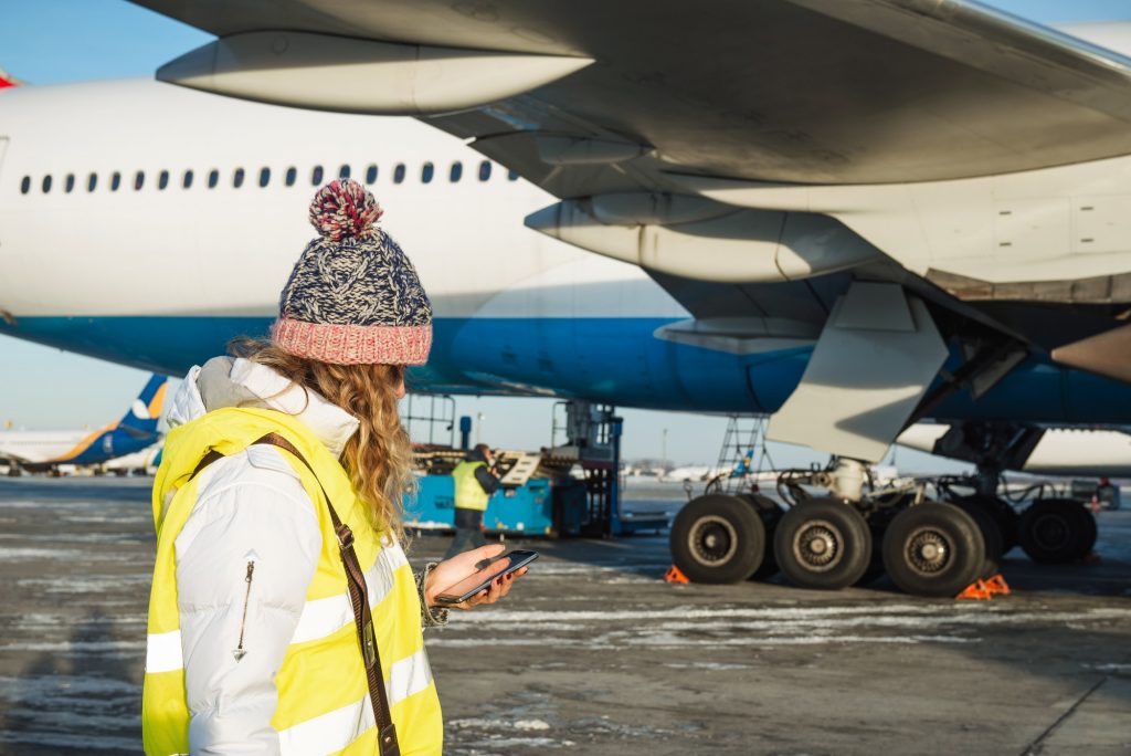 Big airplane boarding at the international airport. Service team inspecting the security of aircraft